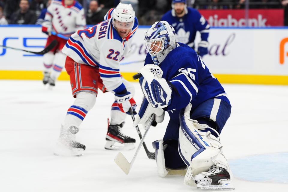 Toronto Maple Leafs goaltender Ilya Samsonov (35) makes a save as New York Rangers' Jonny Brodzinski (22) looks on during the third period of an NHL hockey game in Toronto on Saturday, March 2, 2024. (Frank Gunn/The Canadian Press via AP)