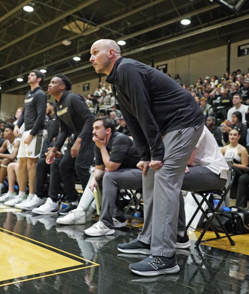 Bryant men's basketball coach Phil Martelli Jr. works from the sideline.