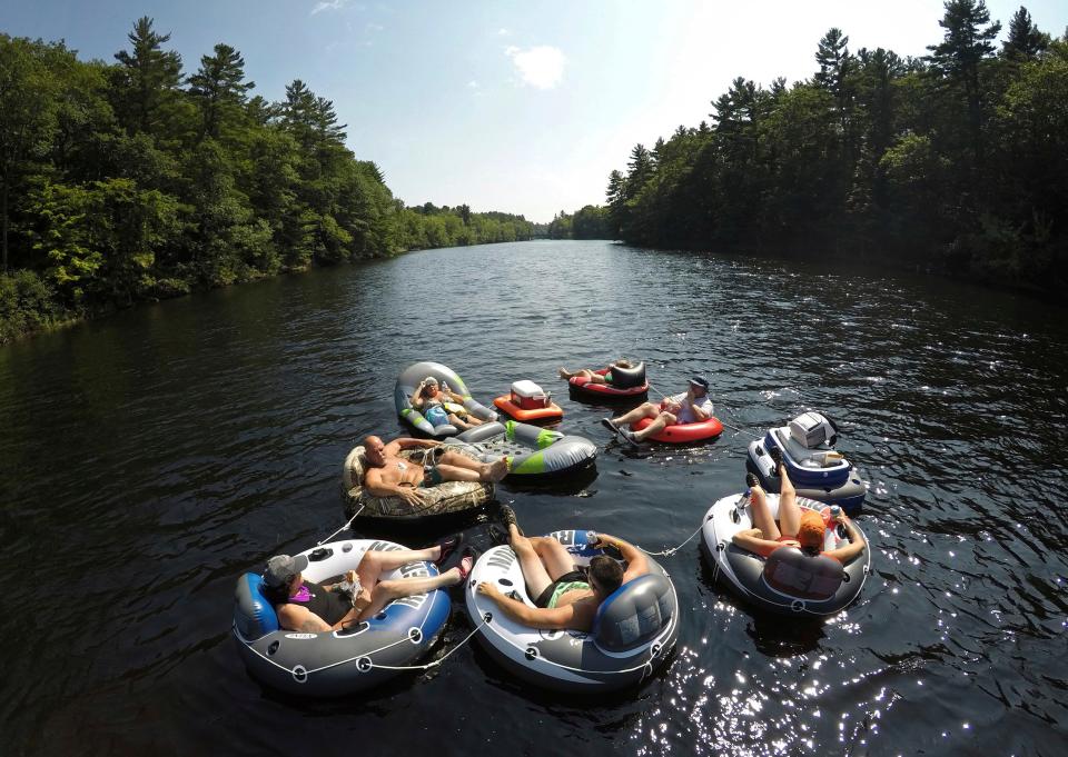 A flotilla of friends from Biddeford, Maine, raft down the Saco River at Bar Mills in Buxton, Maine.