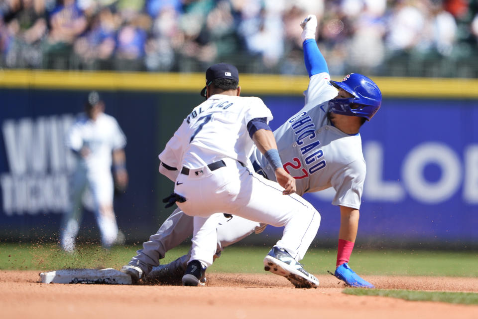 Seattle Mariners second baseman Jorge Polanco (7) catches Chicago Cubs designated hitter Seiya Suzuki trying to steal second during the fifth inning of a baseball game Sunday, April 14, 2024, in Seattle. (AP Photo/Lindsey Wasson)