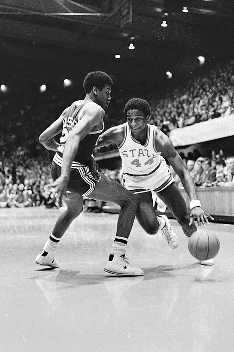 FILE - North Carolina State forward David Thompson (44) drives toward the basket against University of North Carolina's Lew Massey, left, during first period action in their NCAA college basketball game in Raleigh, N.C., March 1, 1975. (AP Photo/Harold Valentine, File)