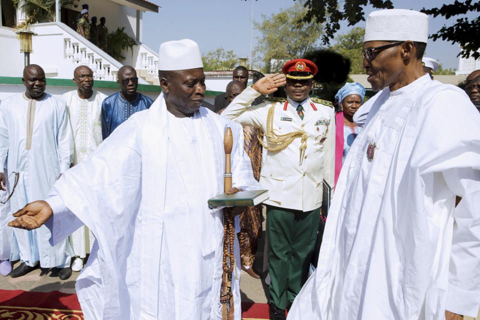 In this photo released by the Nigeria State House, Gambia President, Yahya Jammeh, left, speaks with Nigeria President Muhammadu Buhari, upon arrival in Banjul Gambia, Friday Jan.13, 2017. Nigeria's president was leading a regional delegation to Gambia in a last-ditch attempt Friday to persuade its longtime leader to step down and allow his rival's inauguration next week, while fears grow that the impasse could turn violent. (Bayo Omoboriowo/Nigeria State House via AP)