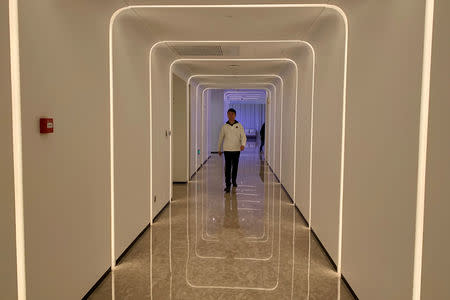A staff member walks in the hallway during a demonstration to the media at Alibaba Group's futuristic FlyZoo hotel in Hangzhou, Zhejiang province, China January 22, 2019. REUTERS/Xihao Jiang