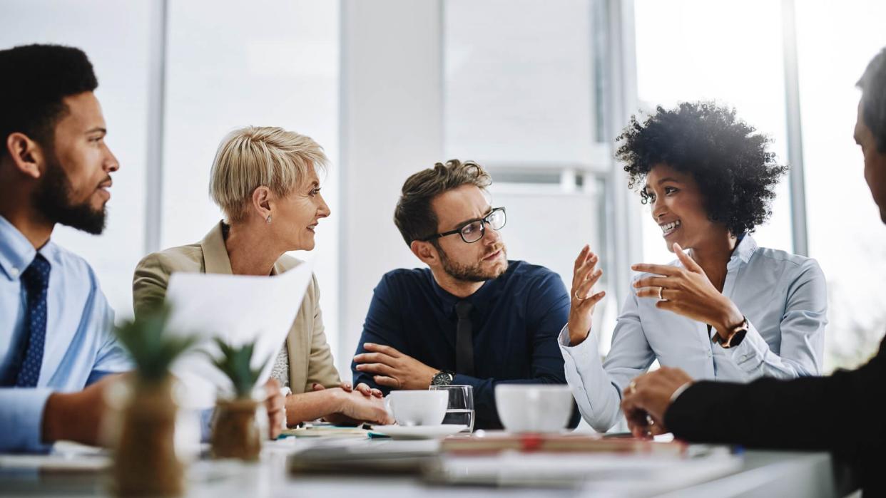 Shot of a group of businesspeople sitting together in a meeting.