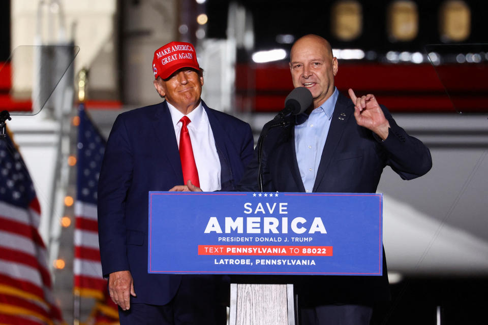 Trump looks on as Pennsylvania gubernatorial candidate Doug Mastriano speaks at a rally in Latrobe on Saturday. 