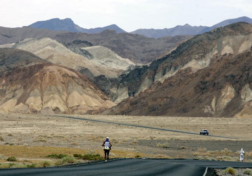 FILE - In this July 23, 2007, file photo, Valmir Nunes, of Brazil, runs in Kiehl's Badwater Ultramarathon in Death Valley, Calif. The race start line was at Badwater, Death Valley, which marks the lowest elevation in the Western Hemisphere at 280 feet below sea level. The race finished after 135 miles at the Mount Whitney Portals at 8,360 feet. Death Valley National Park is putting the brakes on ultramarathons and other extreme sports events that involve running and cycling until rangers can determine how safe it is to hold those competitions in a place that records the hottest temperatures on Earth. (AP Photo/Chris Carlson, File)