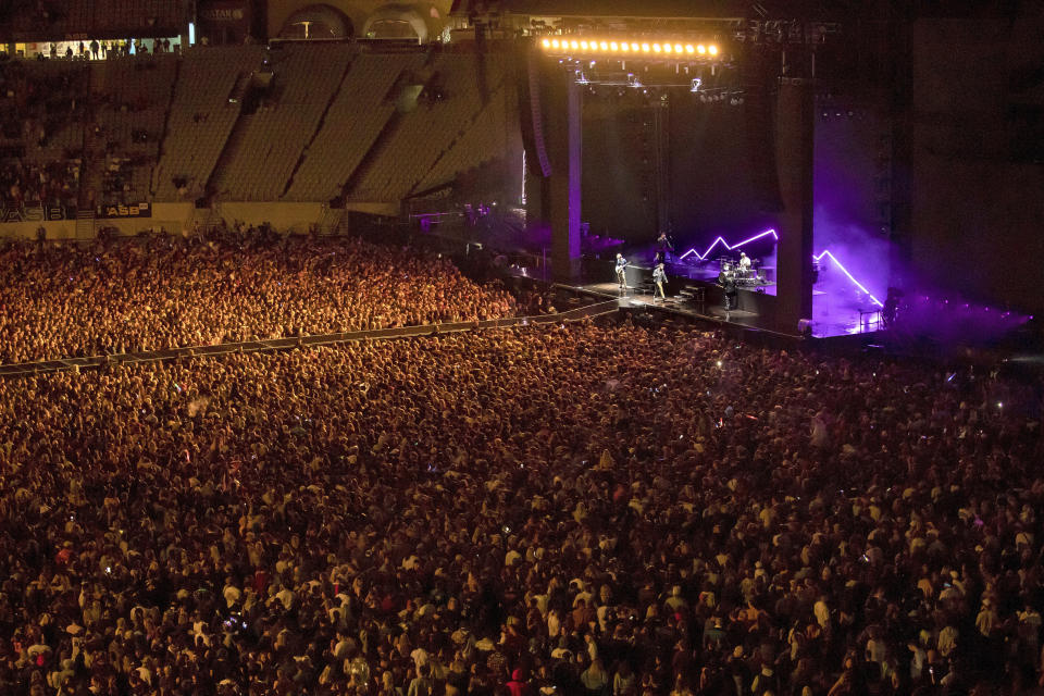 New Zealand band Six60 perform at Eden Park in Auckland, New Zealand, Saturday, April 24, 2021. Six60 is being billed as the biggest live act in the world since the coronavirus pandemic struck after New Zealand stamped out the spread of the virus, allowing life to return to normal. On Saturday, the band played a remarkable finale to their latest tour, performing in front of 50,000 people at the first-ever concert at Auckland's Eden Park.(AP Photo/David Rowland)