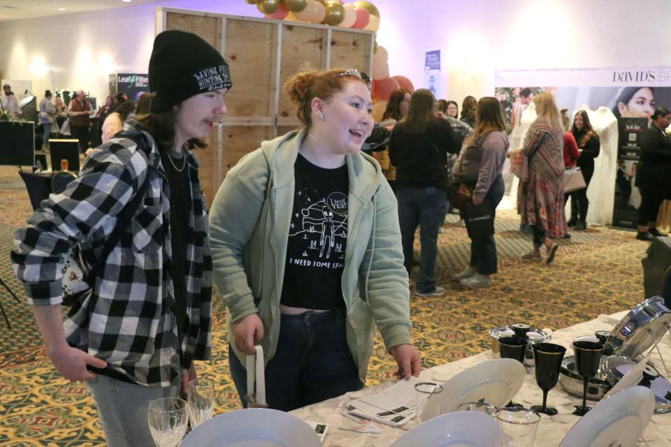 Paden Mick and Dakota Becker sign up for dishes at the 2023 Amarillo Bridal Show held at the Amarillo Civic Center Sunday afternoon.