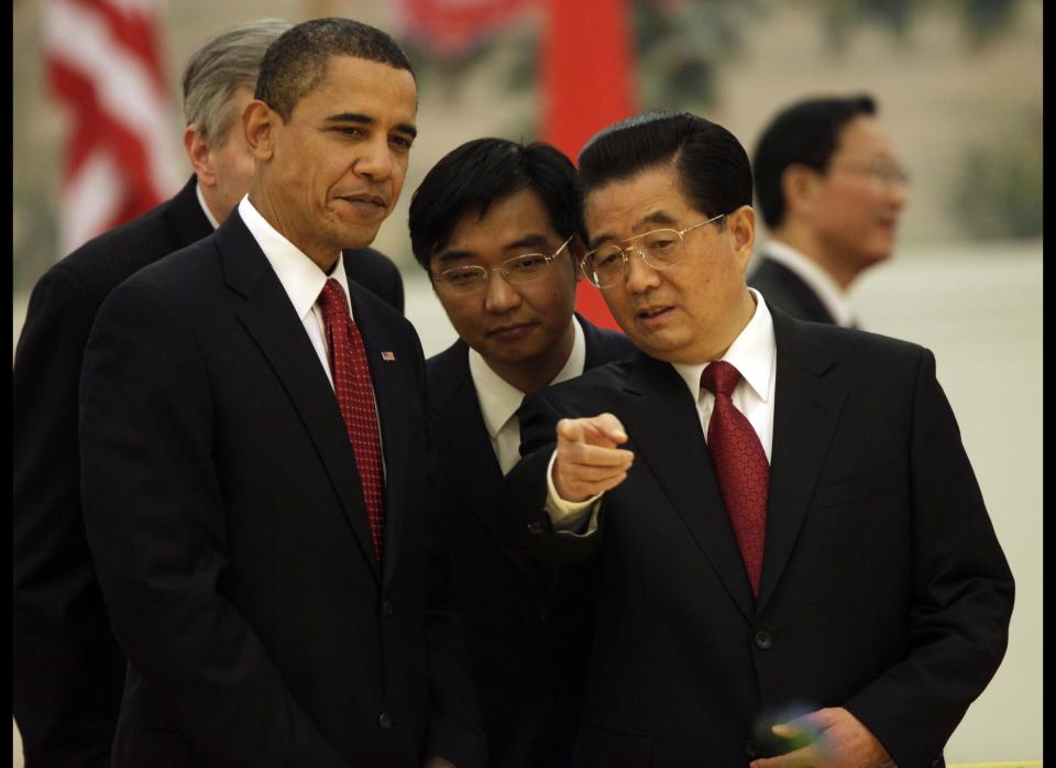 President Barack Obama, left, listens to Chinese President Hu Jintao, as they attend a Nov. 2009 state dinner reception at the Great Hall of the People in Beijing.