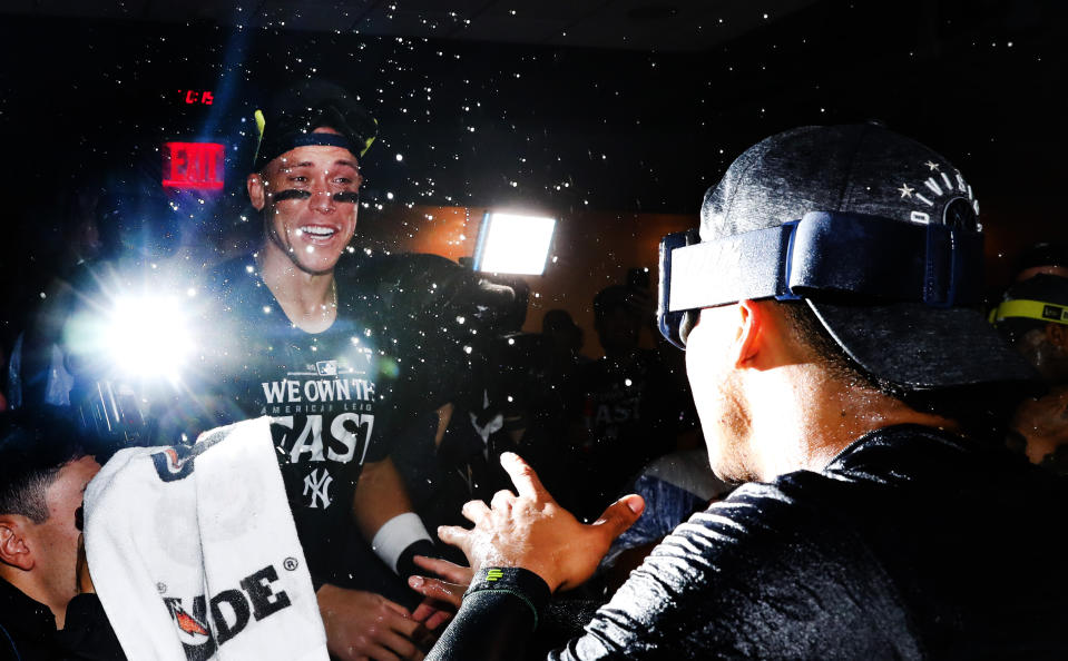 New York Yankees outfielder Aaron Judge, left, celebrates with teammates after clinching the American League East title in a baseball game against the Baltimore Orioles, Thursday, Sept. 26, 2024, in New York. (AP Photo/Noah K. Murray)