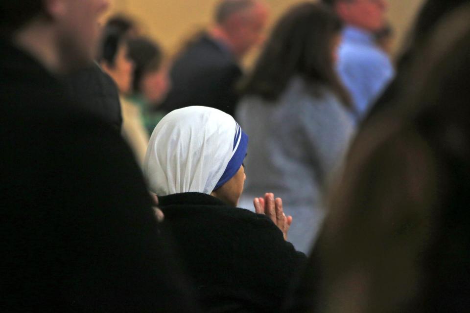 A nun prays during Ash Wednesday service at Saint John Catholic Church, Wednesday, February 10, 2016.