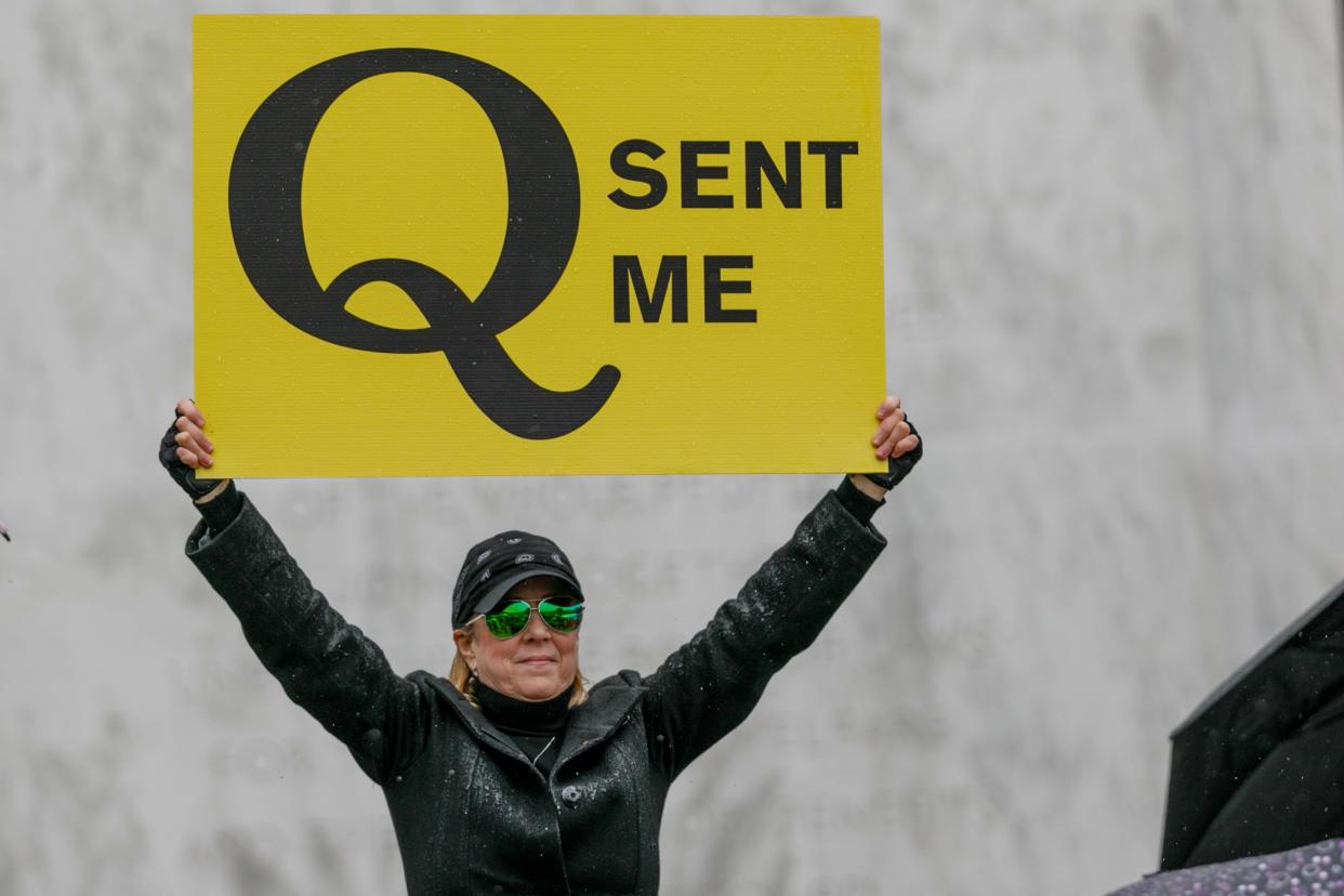 The Q-Anon conspiracy theorists  hold signs during the protest at the State Capitol in Salem, Oregon, United States on May 2, 2020. (John Rudoff/Anadolu Agency via Getty Images)