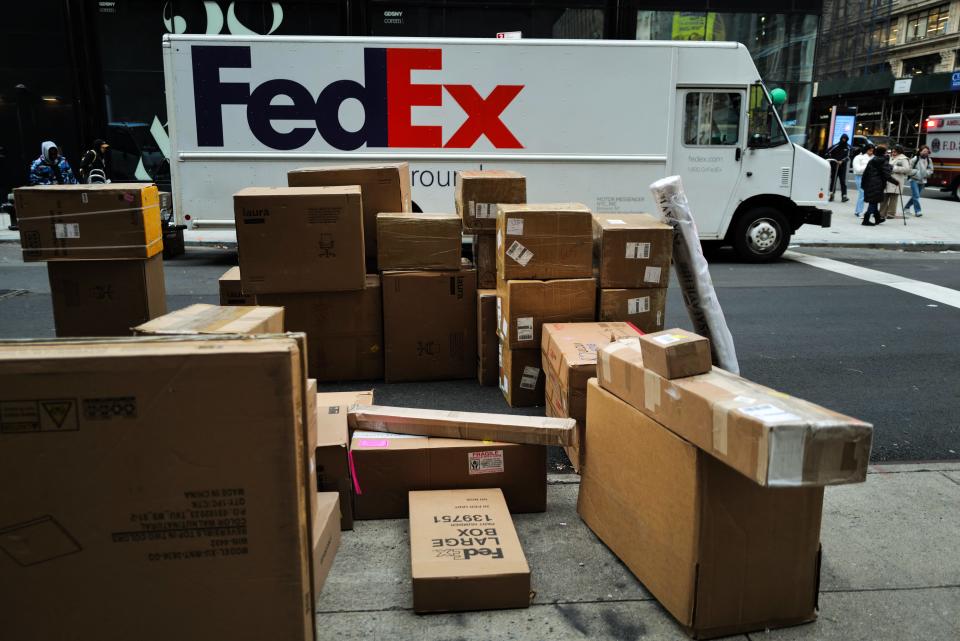 Parcels are seen in a street Dec. 4, 2023 nearby a FedEx truck in a street of the Manhattan borough in New York City.