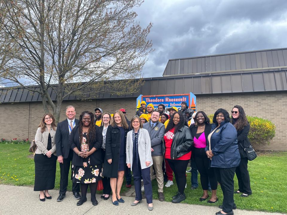 Local representatives and community groups stand in front of Theodore Roosevelt Elementary School in Binghamton.