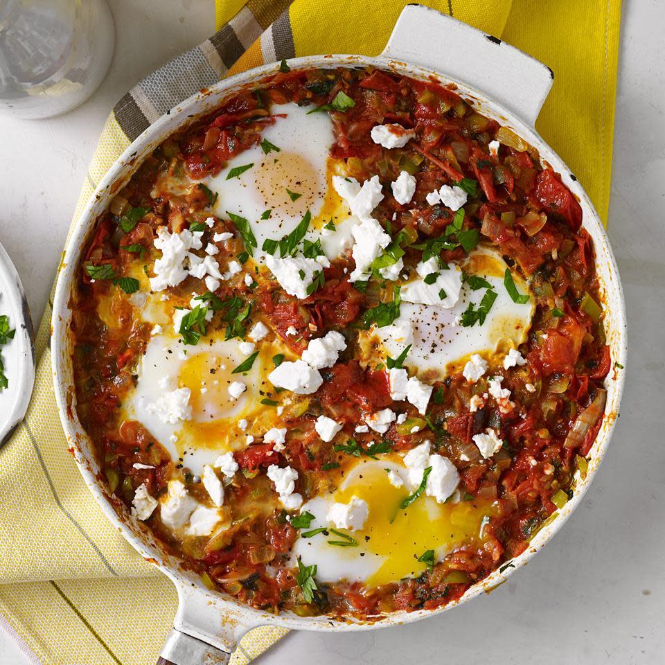 <p>Popular throughout the Middle East and North Africa, shakshuka is a healthy skillet recipe featuring eggs poached in a spicy tomato sauce. To make this variation, we roast the tomatoes and onion with garlic and herbs to intensify their flavors. Serve with warm crusty bread and hot sauce.</p> <p> <a href="https://www.eatingwell.com/recipe/252833/shakshuka-with-roasted-tomatoes/" rel="nofollow noopener" target="_blank" data-ylk="slk:View Recipe" class="link ">View Recipe</a></p>