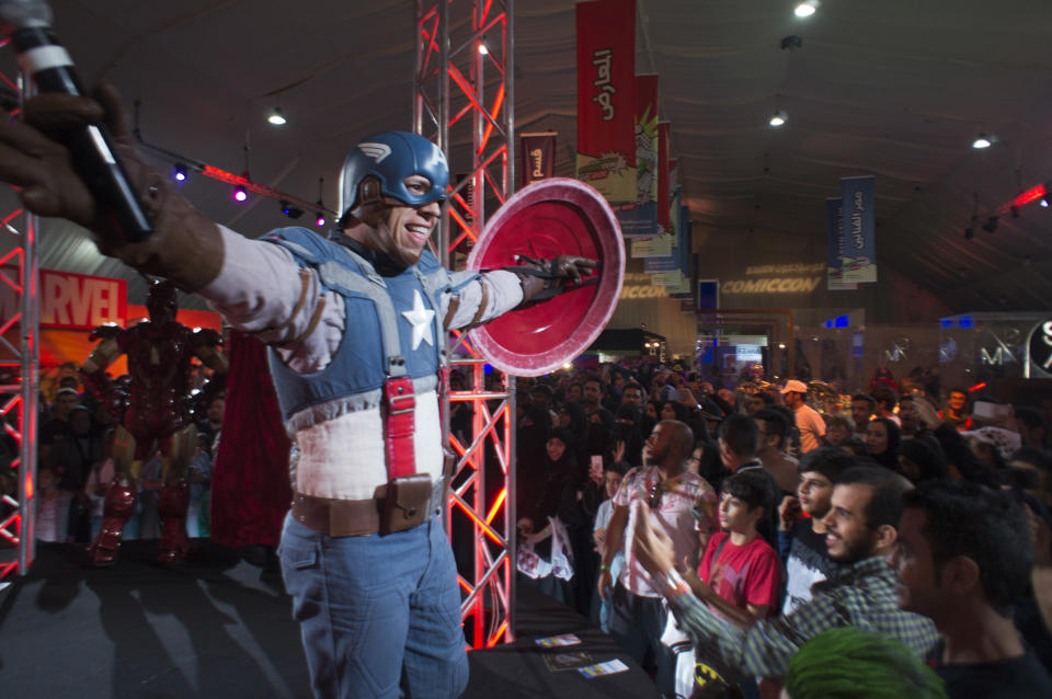 FILE - In this Friday, Feb. 17, 2017, file photo, a man wears a Captain America costume representing a fictional superhero appearing in American comic books published by Marvel Comics, during the Saudi Comic Con (SCC) which is the first event of its kind to be held in Jiddah, Saudi Arabia. The kingdom, which bans movie theaters and other entertainment venues, is challenging its ultraconservative image and loosening the reins on fun by opening its doors to live shows, including some American ones. (AP Photo, File)