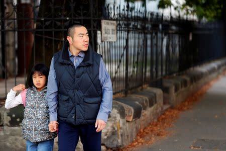 Yan Ding, a Chinese immigrant to Hungary who received an EU residency permit through the purchase of a special 300,000 euro government bond, walks his daughter to school in Budapest September 28, 2016. REUTERS/Laszlo Balogh