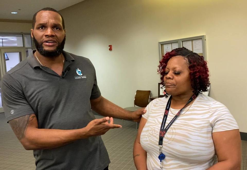 Jerome Lawson, director of Cure Violence Columbus, left, and Kenyada McKenzie, whose 5-year-old nephew was wounded in the eye during a recent shooting in Columbus, Georgia, answer questions from the media after a recent Columbus City Council meeting.