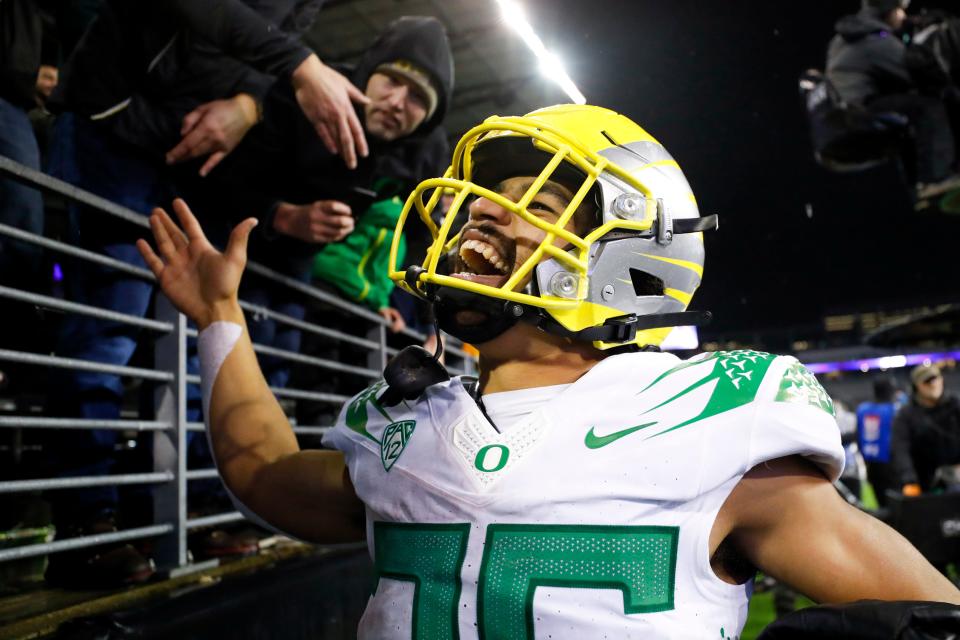 Oregon Ducks running back Travis Dye (26) celebrates with fans following a 26-16 victory against the Washington Huskies at Alaska Airlines Field at Husky Stadium.