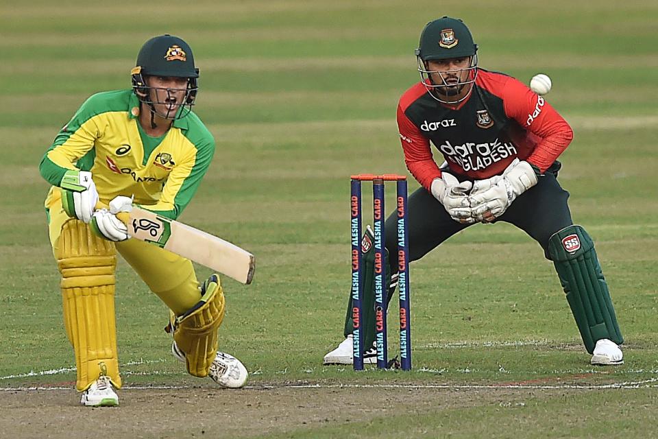 Australia's wicketkeeper Alex Carey (pictured left) plays a shot against Bangladesh.