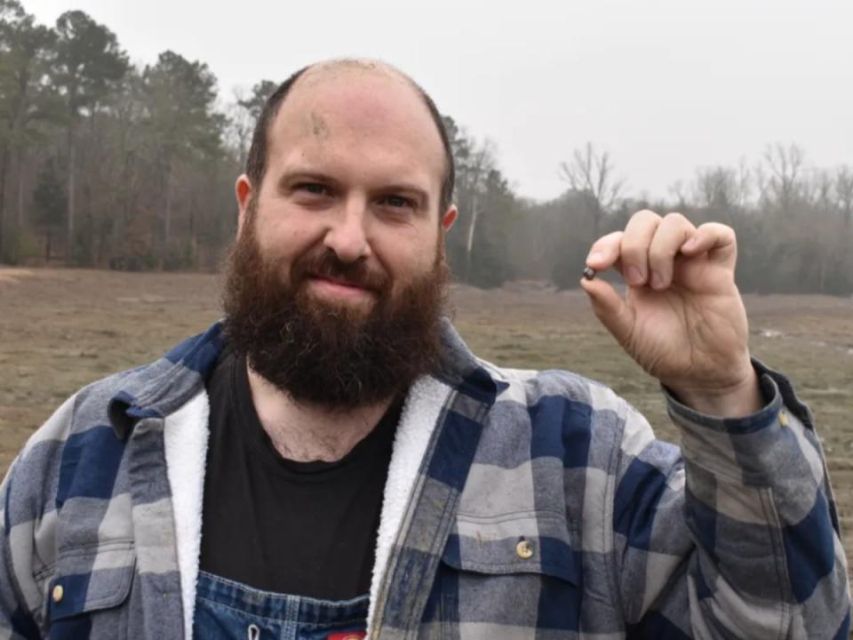 Julien Navas, of Paris, with the 7.46-carat diamond he found at Crater of Diamonds State Park in Arkansas (Arkansas State Parks)