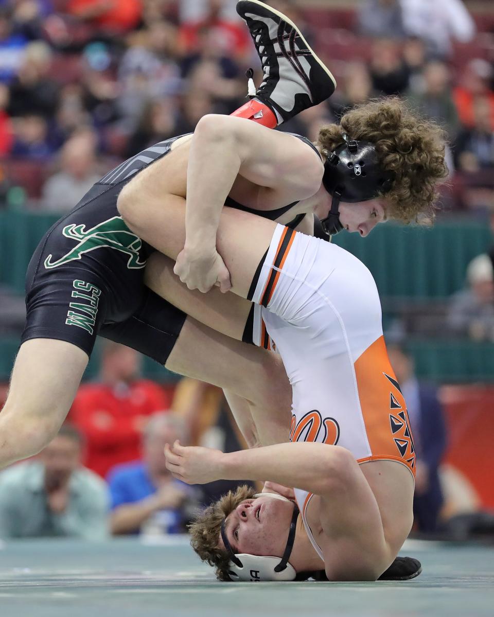 STVM's Bryce Skinner, top, flips over Waynesville's Matt Ellis during their 126 pound match in the Division II championship round of the OHSAA State Wrestling Tournament at the Jerome Schottenstein Center on Sunday.