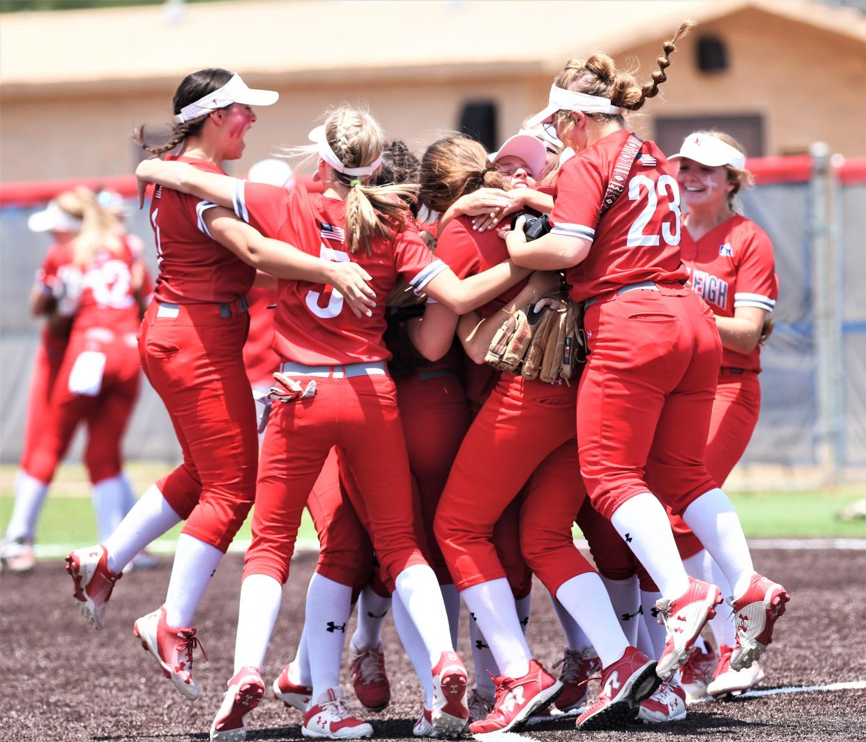 Hermleigh players mob pitcher Summer Smith after the Lady Cardinals got the final out in a 13-6 victory over Eula in Game 2 of the Region I-1A finals Saturday at Cooper's Cougar Diamond.