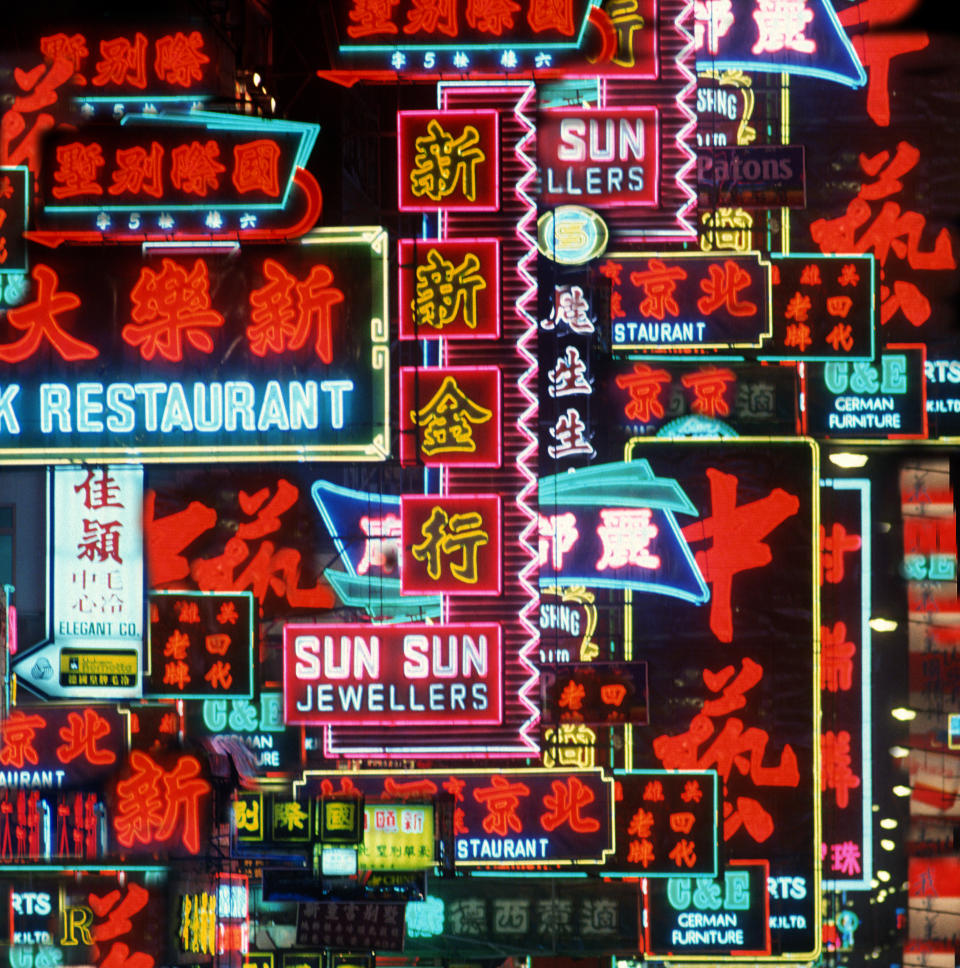 Multiple images in a composite of many shop signs in neon on Nathan road in Kowloon shopping district.