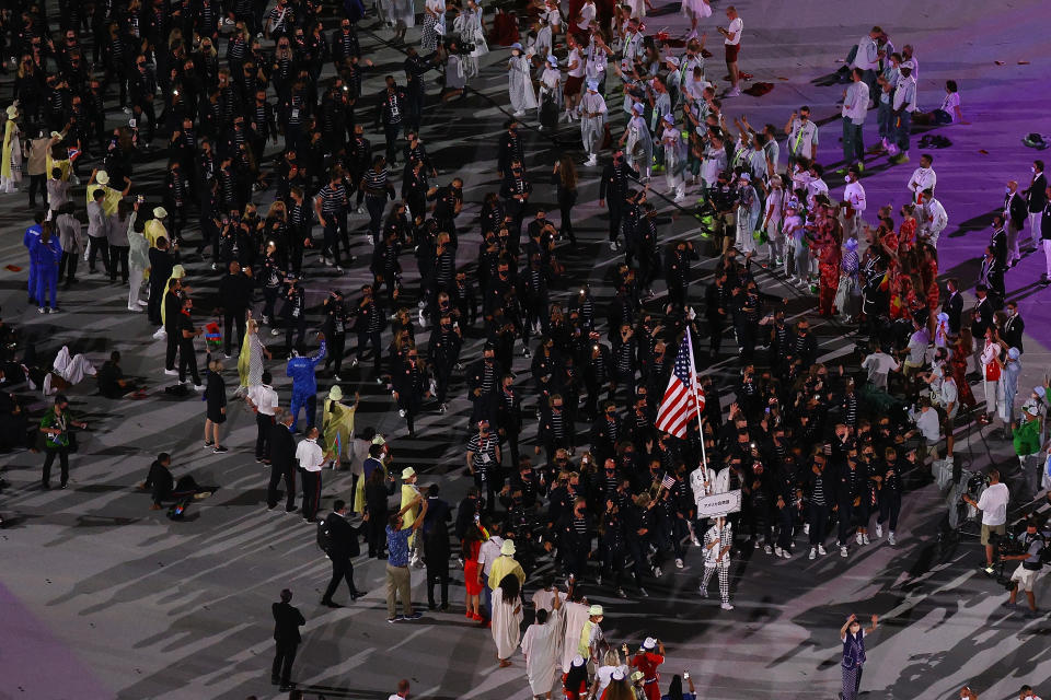 <p>TOKYO, JAPAN - JULY 23: Flag bearers Sue Bird and Eddy Alvares of Team United States lead their team during the Opening Ceremony of the Tokyo 2020 Olympic Games at Olympic Stadium on July 23, 2021 in Tokyo, Japan. (Photo by Richard Heathcote/Getty Images)</p> 