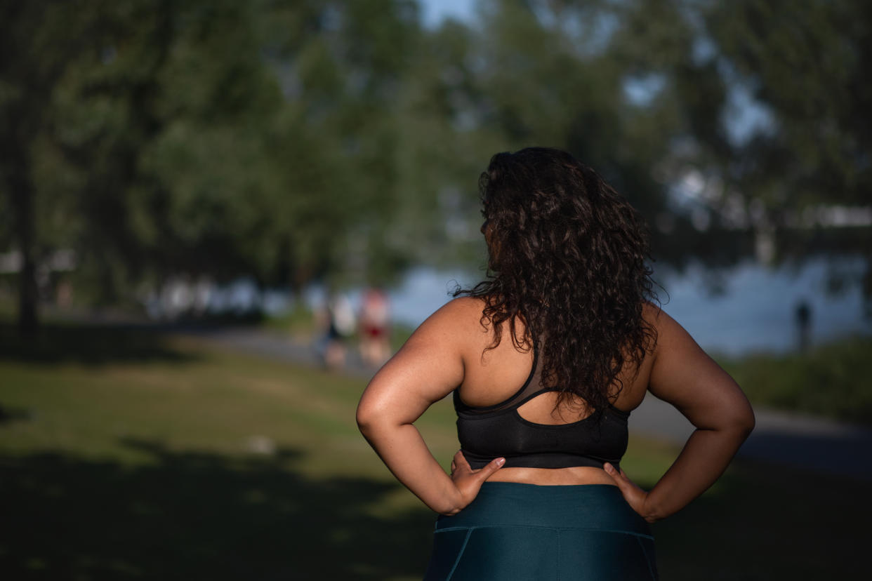 Mixed-race woman doing sport in city.