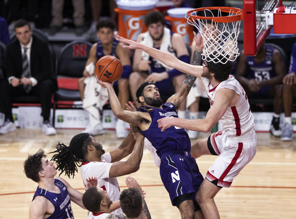Northwestern's Boo Buie, second from right, shoots between Nebraska's Derrick Walker, second from left, and Wilhelm Breidenbach during the second half of an NCAA college basketball game Wednesday, Jan. 25, 2023, in Lincoln, Neb. (AP Photo/Rebecca S. Gratz)