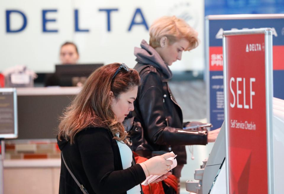 FILE - Travelers use the Delta airlines self check-in at Love Field in Dallas, Nov. 27, 2019. Delta Air Lines will be able to continue operating flights at Dallas Love Field for another six years, under a settlement approved by the city council. The agreement, which passed without debate this week, appears to end a long court fight over gates at the city-owned airport near downtown Dallas that is dominated by Southwest Airlines. (AP Photo/LM Otero, file) ORG XMIT: NYPS211