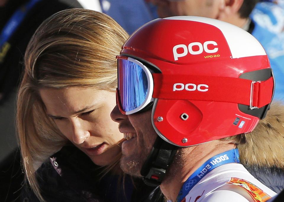 United States' Bode Miller smiles as he stands alongside his wife Morgan Miller after completing men's downhill combined training at the Sochi 2014 Winter Olympics, Thursday, Feb. 13, 2014, in Krasnaya Polyana, Russia. (AP Photo/Christophe Ena)