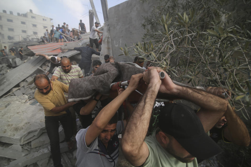 Palestinians are evacuated from buildings hit in the Israeli bombardment of the Gaza Strip in Rafah, Sunday, Oct. 22, 2023. (AP Photo/Hatem Ali)