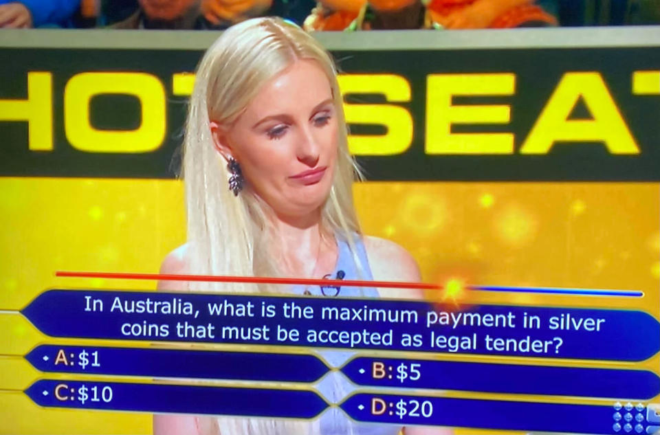 Millionaire Hot Seat contestant Cindy mulls the answer about using silver coins as payment.