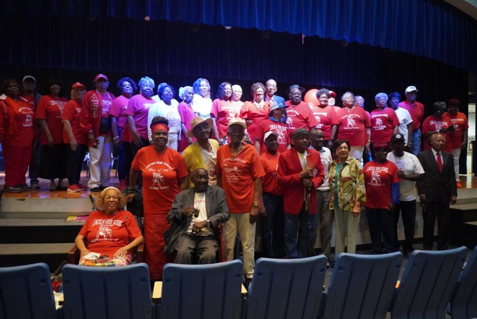 Members of the the Lincoln High School Alumni Association posed for a picture in the Lincoln Middle School Auditorium on March 27 during the Lincoln High School memorial wall ceremony.