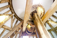 <p>The four-storey structure has been carefully restored, boasting massive wooden beams that span each floor up to the original upright shaft giant spur wheel and sack hoist. Airbnb) </p>