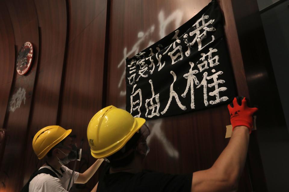 Protesters put up a sign after breaking into the parliament chambers of the government headquarters in Hong Kong on July 1, 2019, on the 22nd anniversary of the city's handover from Britain to China. (Photo: Vivek Prakash/AFP/Getty Images)