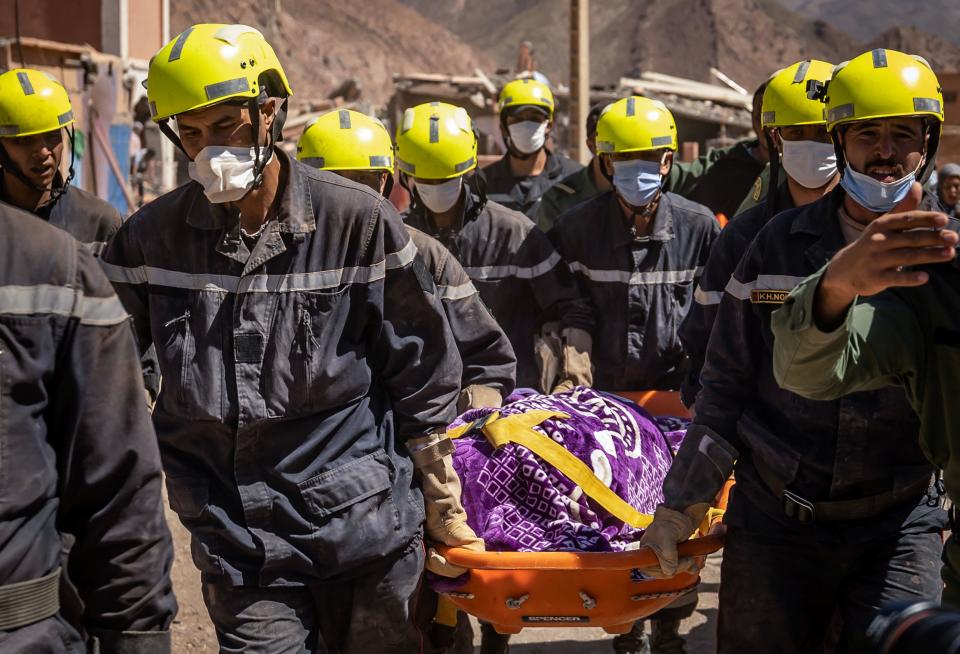 Rescuers carry an earthquake victim out of the rubble in Talat N'Yacoub village of al-Haouz province in Morocco on Sept. 11, 2023. / Credit: FADEL SENNA/AFP via Getty Images