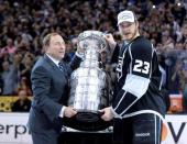 Jun 13, 2014; Los Angeles, CA, USA; NHL commissioner Gary Bettman (left) presents Los Angeles Kings right wing Dustin Brown (23) with the Stanley Cup after defeating the New York Rangers game five of the 2014 Stanley Cup Final at Staples Center. Mandatory Credit: Gary A. Vasquez-USA TODAY Sports