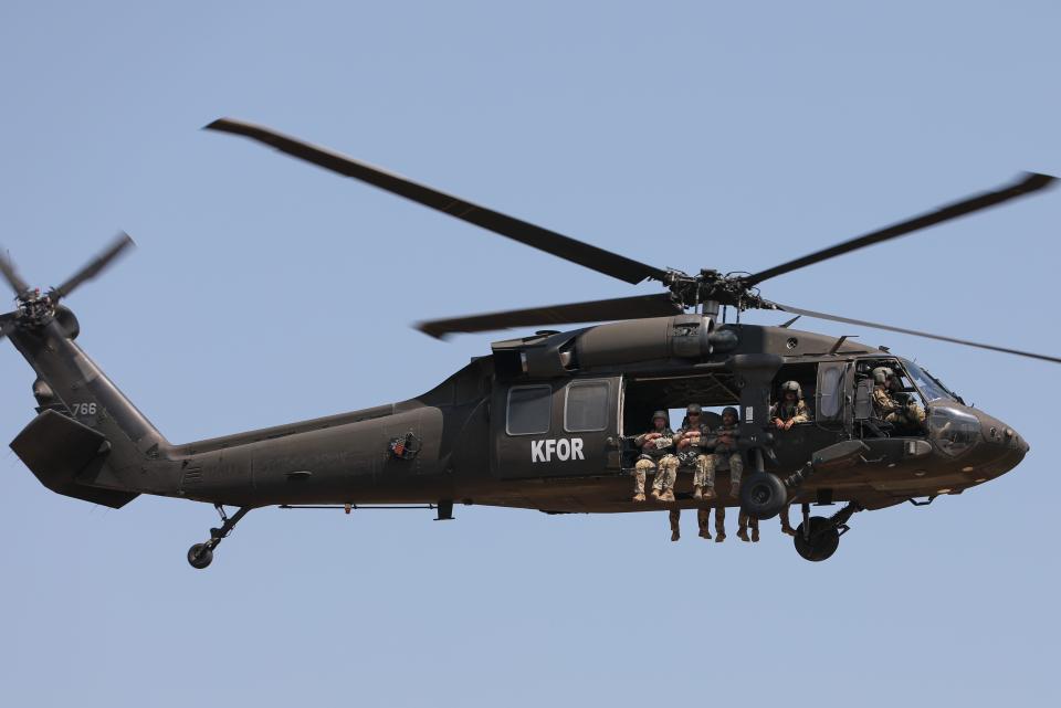 Paratroopers from Rhode Island’s Charlie Company, 1/143rd Airborne Infantry, prepare to jump from a lift company (A-1/126th) helicopter.