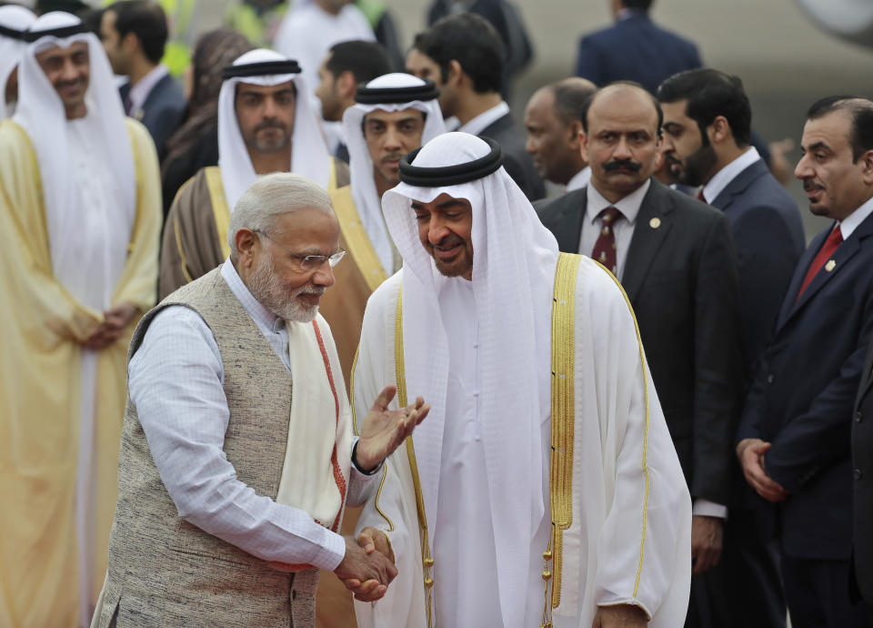 FILE - In this Jan. 24, 2017 file photo, Indian Prime Minister Narendra Modi, left, gestures as he receives Abu Dhabi's Crown Prince, Sheikh Mohammed bin Zayed Al Nahyan at the airport in New Delhi, India. Gulf Arab countries have remained mostly silent as India’s government moved to strip the Indian-administered sector of Kashmir of its limited autonomy, imposing a sweeping military curfew in the disputed Muslim-majority region and cutting off residents from all communication and the internet. This muted response is underwritten by more than $100 billion in annual trade with India that makes it one of the Arabian Peninsula’s most prized economic partners. (AP Photo/Manish Swarup, File)