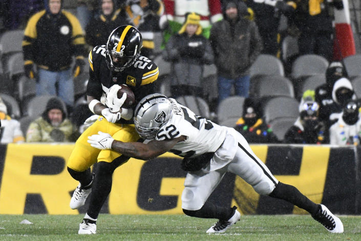 Pittsburgh Steelers running back Najee Harris (22) is tackled by Las Vegas Raiders linebacker Denzel Perryman (52) during the first half of an NFL football game in Pittsburgh, Saturday, Dec. 24, 2022. (AP Photo/Don Wright)
