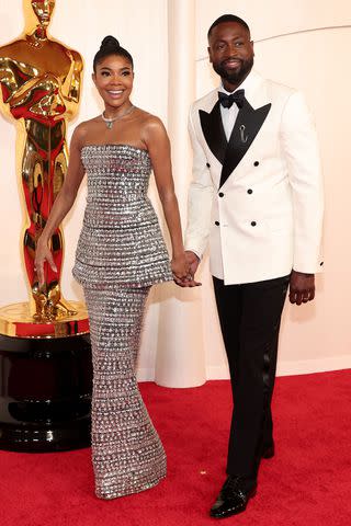 <p>John Salangsang/Shutterstock</p> Gabrielle Union and Dwyane Wade at the 2024 Oscars.