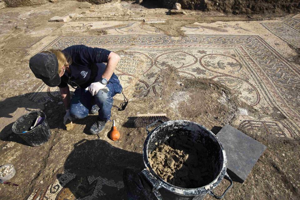 Archaeologist from Israel's Antiquities Authority works at an excavation site where a mosaic floor of an ancient Byzantine church was uncovered near Kiryat Gat
