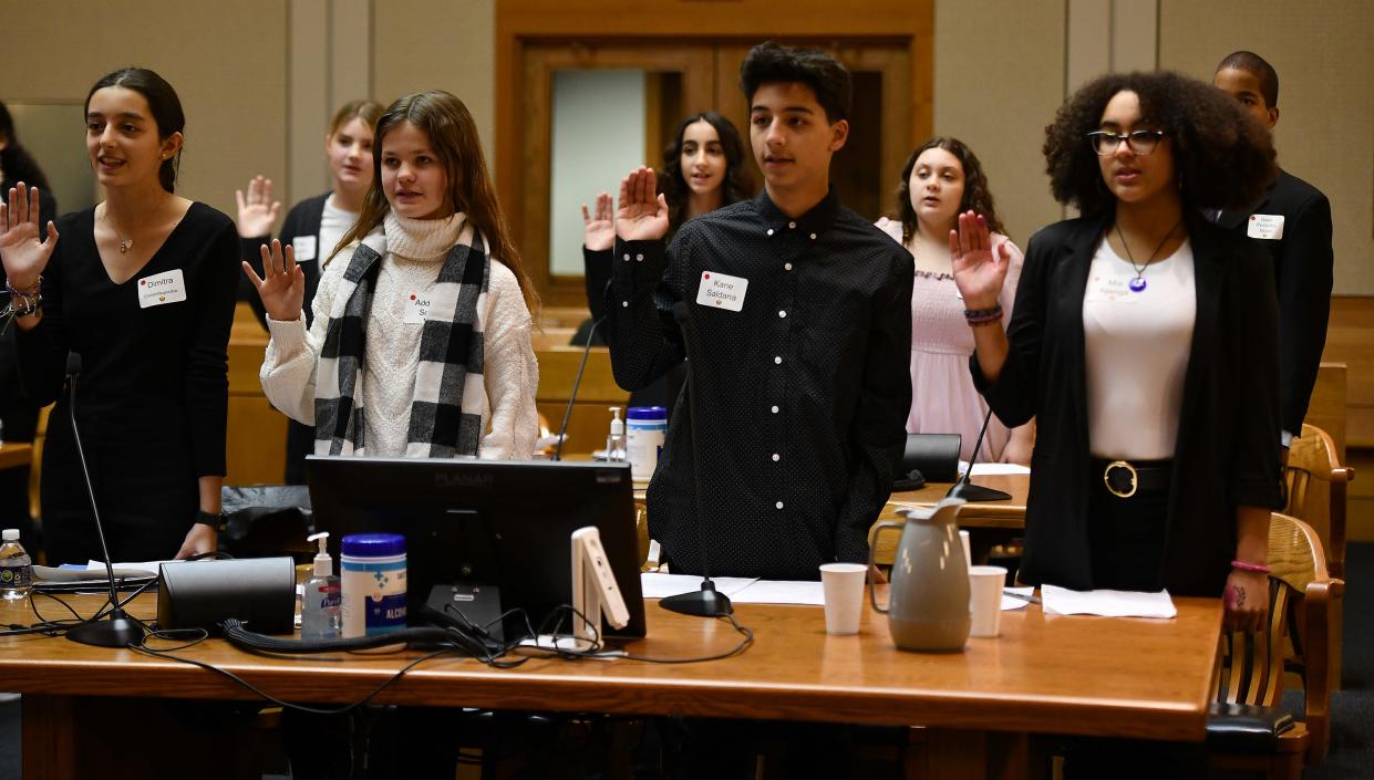 Plaintiffs, from left, Dimitra Christofilopoulou, Addison Scott, Kane Saldana and Mia Njenga are sworn in with fellow Forest Grove Middle School students for a mock trial at the federal courthouse Monday evening.