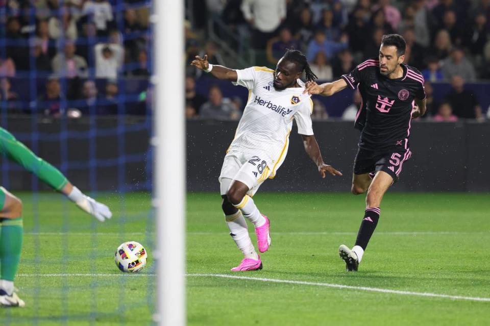 Feb 25, 2024; Carson, California, USA; Inter Miami CF defender Sergio Busquets (5) pulls back LA Galaxy forward Joseph Paintsil (28) during the first half at Dignity Health Sports Park. Mandatory Credit: Kiyoshi Mio-USA TODAY Sports