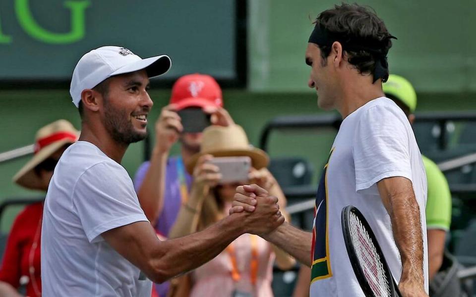 Roger Federer shakes hands with his hitting partner Adrian Escarate (L) prior to the men’s final at the Miami Open between Roger Federer and Rafael Nadal at the Crandon Park Tennis Center on April 2, 2017. Escarate is a DACA recipient who says tennis is his greatest passion and he hopes to become a sports commentator (Patrick Farrell/Miami Herald)