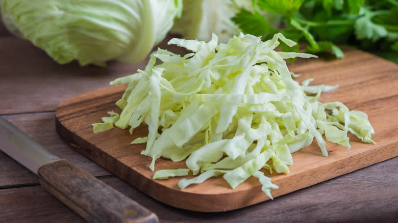 sliced cabbage on wooden board