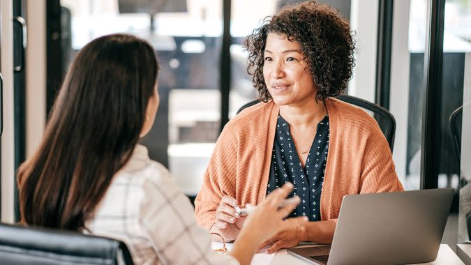 Two women discussing strategy.